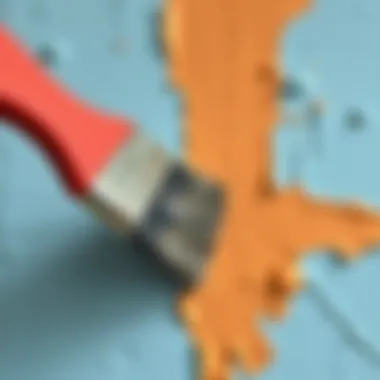 Close-up of a brush applying paint on a wall