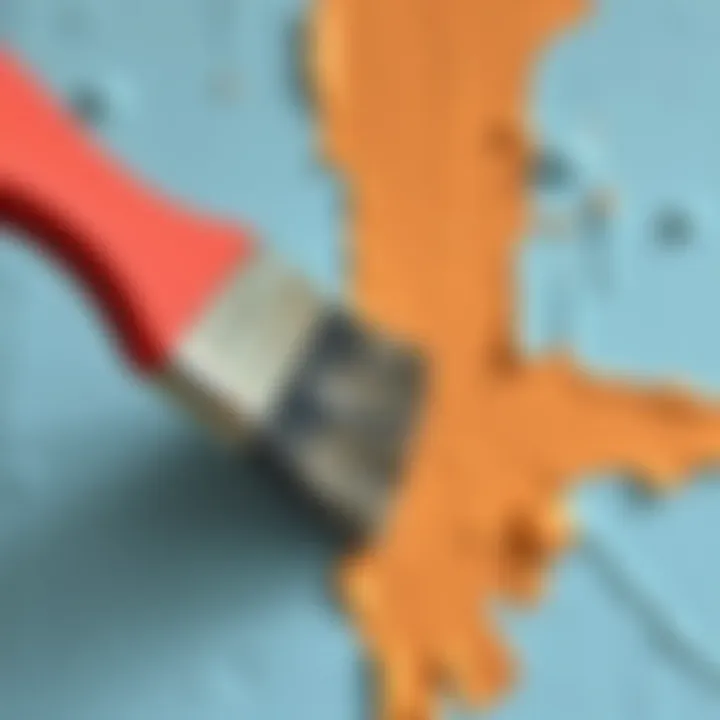 Close-up of a brush applying paint on a wall